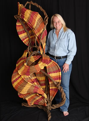 Tina Puckett with her freestanding basket sculpture Dancing
