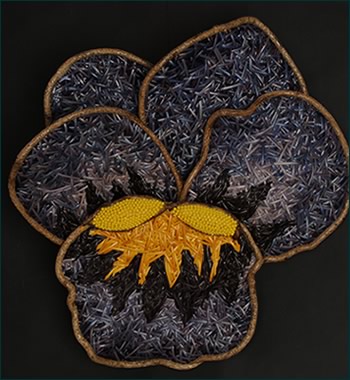 Purple Pansy, a woven flower wall sculpture by basket artist Tina Puckett