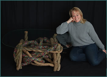 Basket artist Tina Puckett with her custom built, custom-woven end table Swirls of Pastel