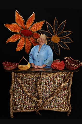 Master basket weaver Tina Puckett pictured with some of her hand-crafted woven works